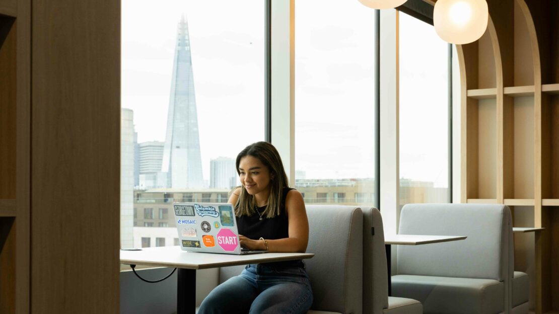 A student studying inside 1 Portsoken building, a part of Northeastern University London's campus in the City of London