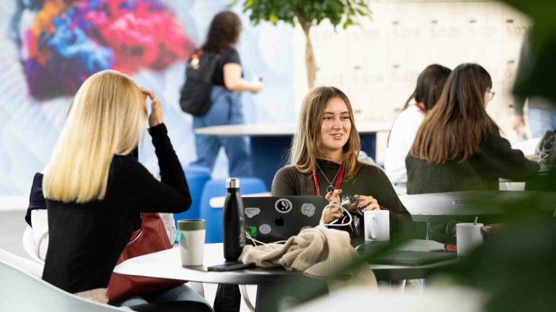 Students socialising inside Northeastern University London's campus building